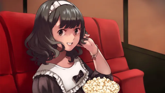 An idol at the movies with a tub of popcorn